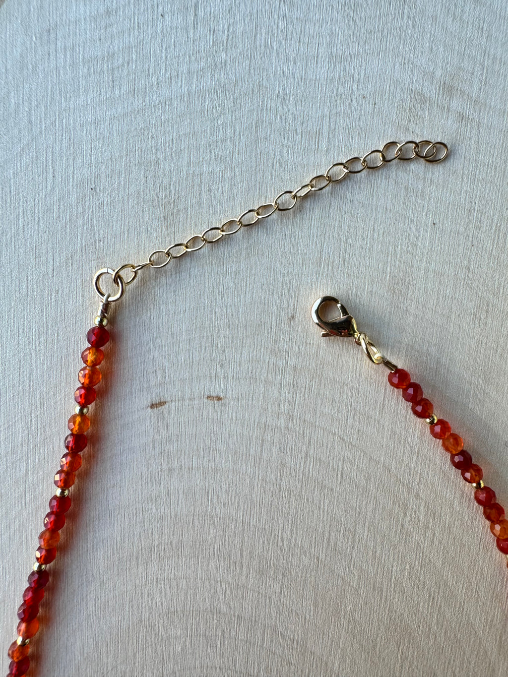 handmade beaded carnelian agate gemstone necklace with 14k gold filled findings, closeup of lobster clasp