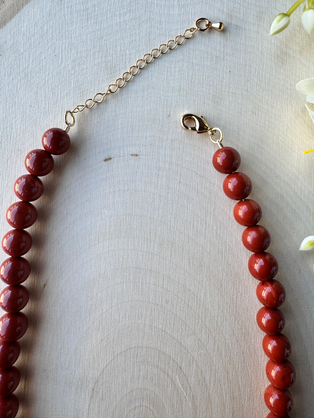handmade red jasper beaded gemstone necklace with 14k gold filled findings, closeup of lobster clasp