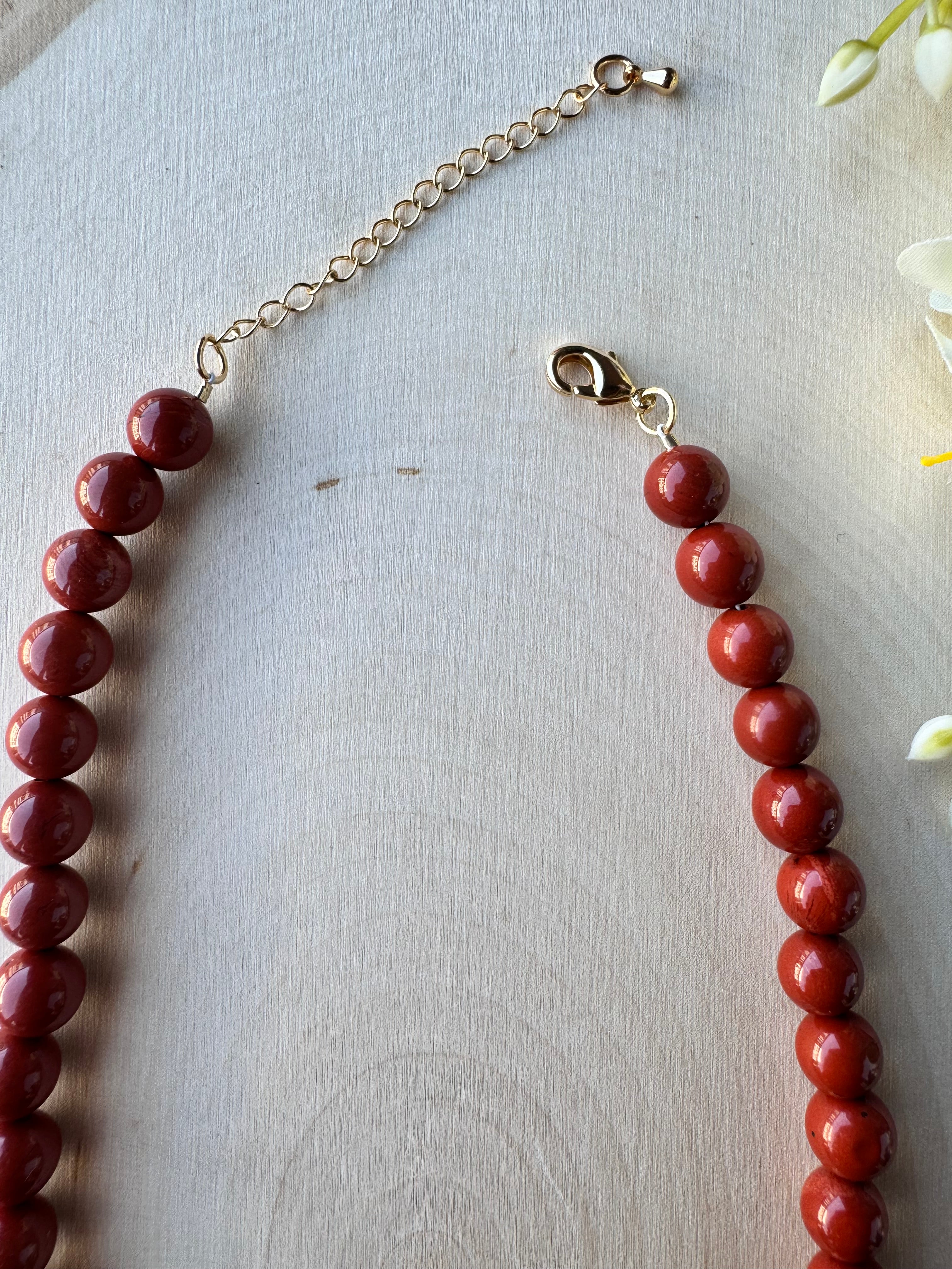 handmade red jasper beaded gemstone necklace with 14k gold filled findings, closeup of lobster clasp