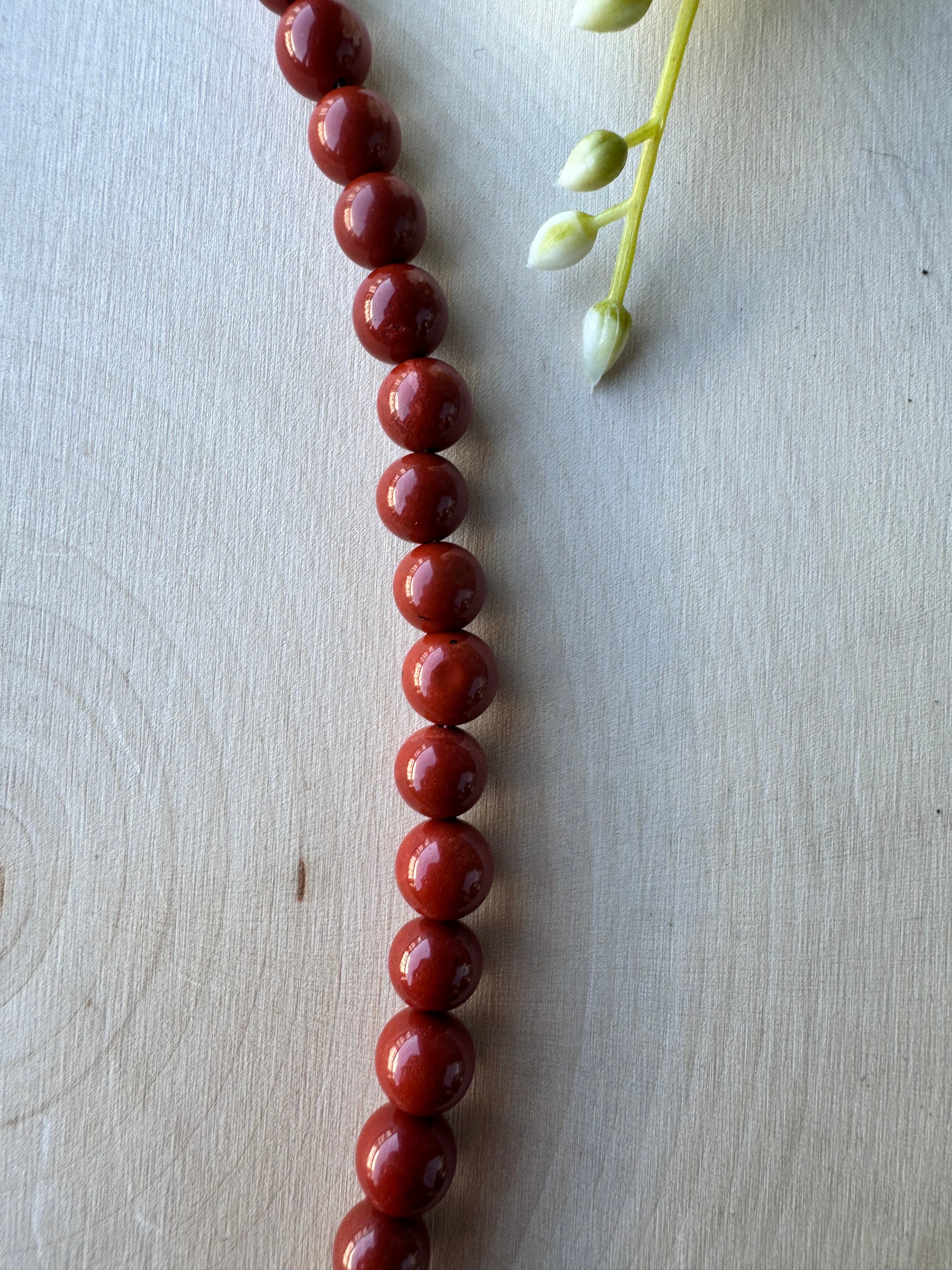 handmade red jasper beaded gemstone necklace with 14k gold filled findings, closeup of round red jasper beads