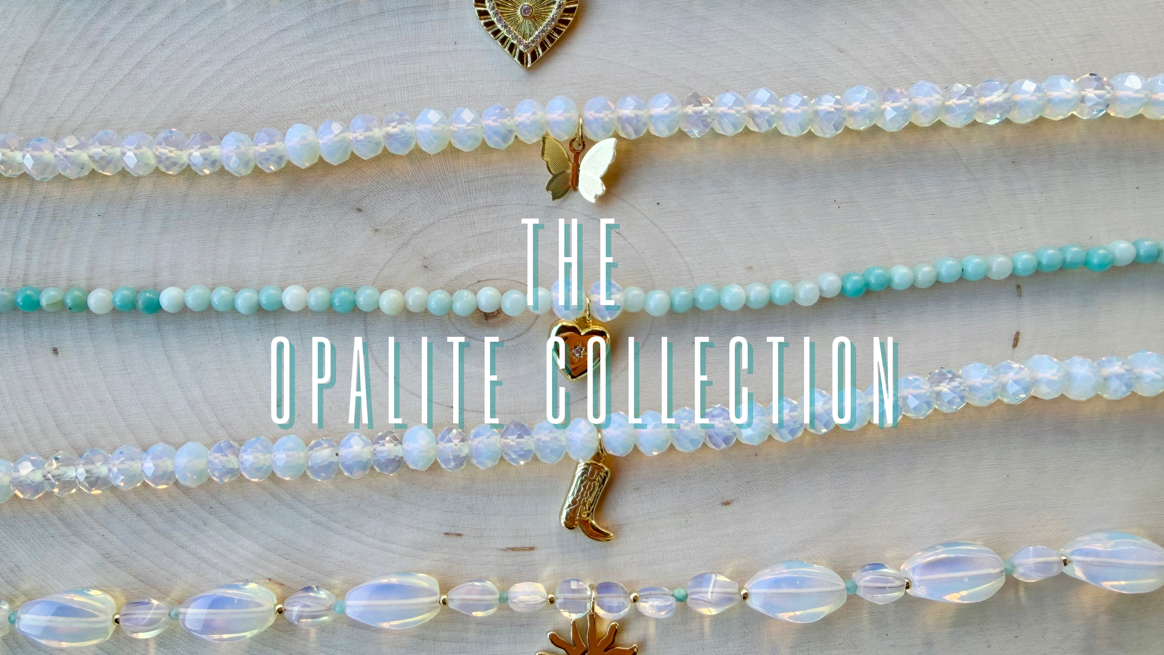Opalite jewelry collection with necklaces on a light wooden surface, featuring the text 'The Opalite Collection'.