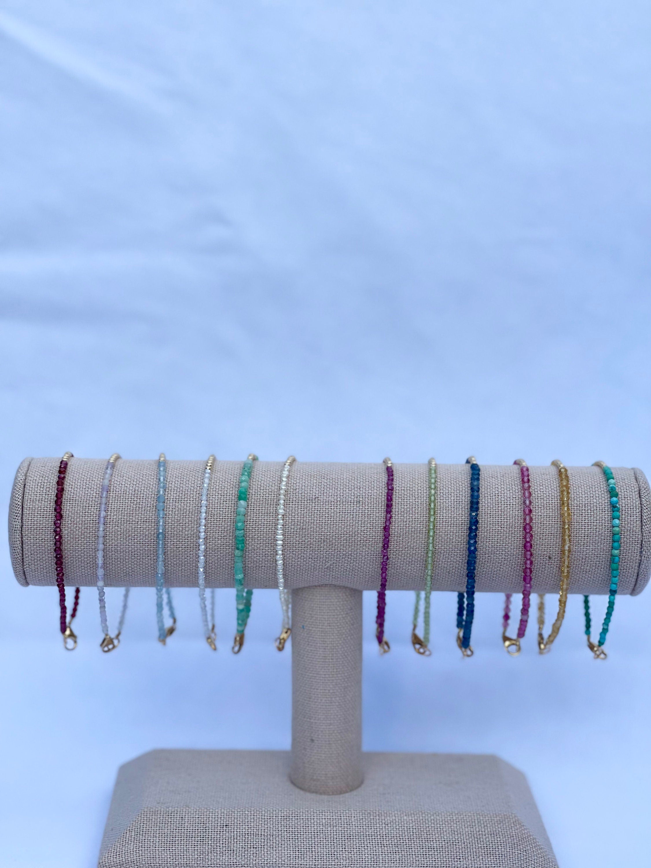 handmade birthstone gemstone bracelet collection. garnet, amethyst, aquamarine, cubic zirconia, emerald, pearl, ruby, peridot, sapphire, pink tourmaline, citrine and turquoise, front view